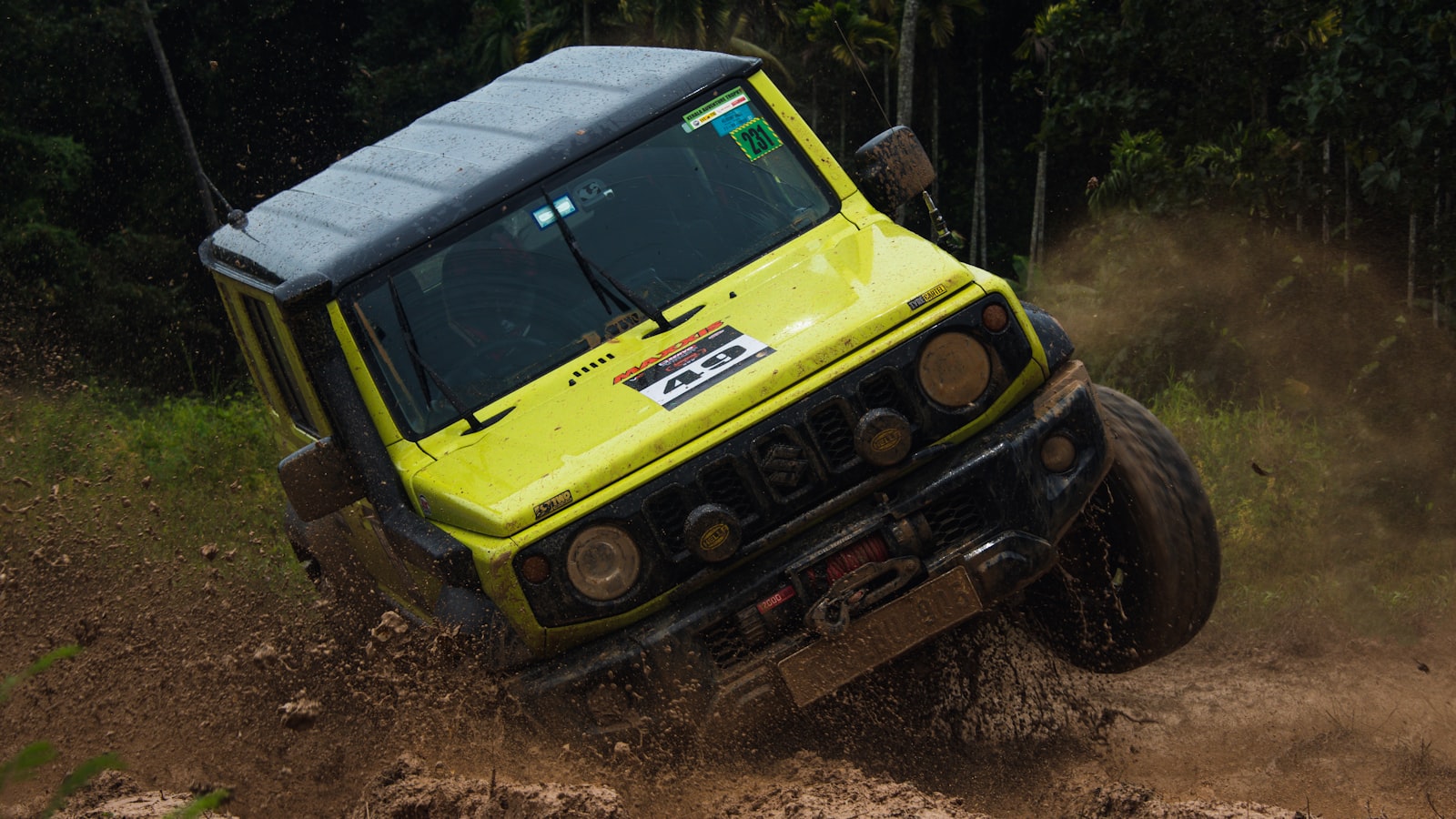 Off-road vehicle kicking up jungle mud